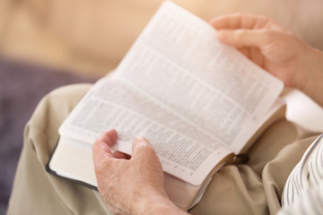 Naklejka premium Close Up of a Man Reading the Holy Bible