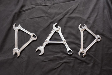 Dad Written with Wrenches on a Black Background