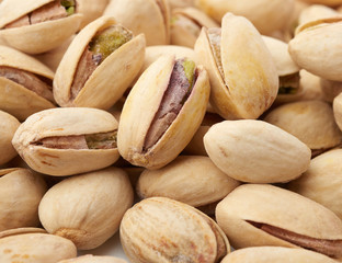 bunch of open pistachios with salt
