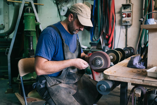 Craftsman making knives in his workshop