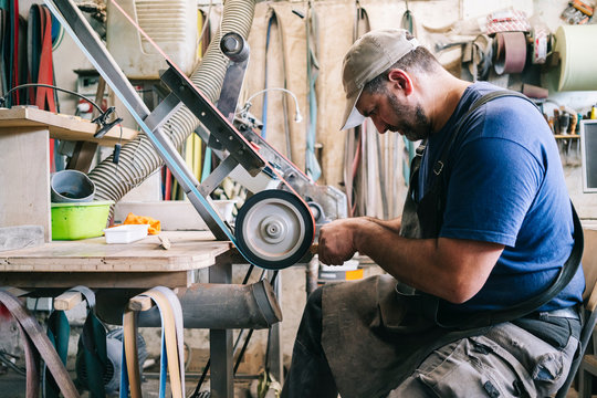 Craftsman making knives in his workshop