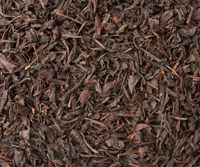 texture of dry black long leaf tea, top view