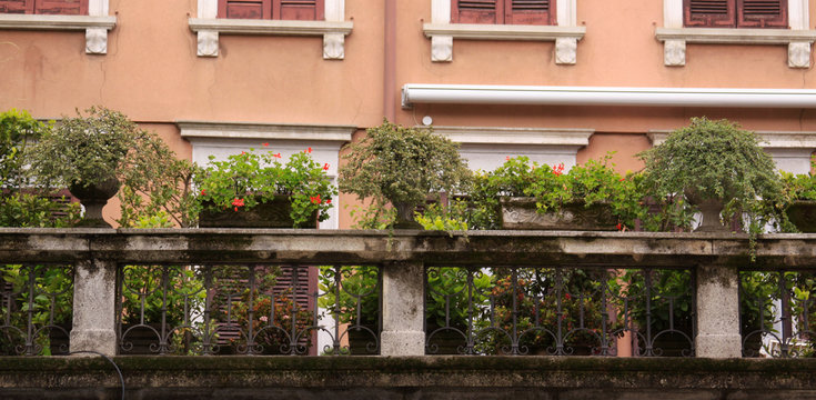 Stone balcony with plants in pots, Milan, Italy
