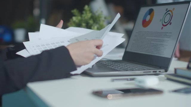 The boss throws documents into the air. Slowmotion