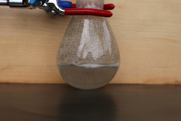 The chemical reaction of the dissolution of a metal in sulfuric acid in a flask, with the release...