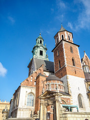 Beautiful architecture and  rooftops of Wawel Castle with blue sky in background.