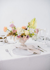 festive table setting with a bouquet of flowers