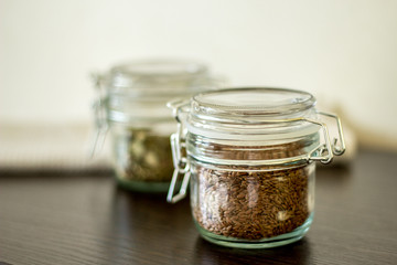 flax seeds in a jar with a lock on the table, pumpkin seeds in a jar with a lock on the table