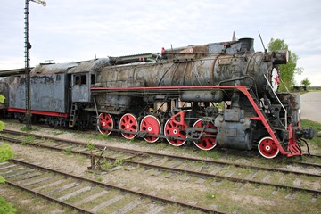 Fototapeta na wymiar Historic antique steam locomotive at the site of the Cineville Film Studio in Latvia. May 2019