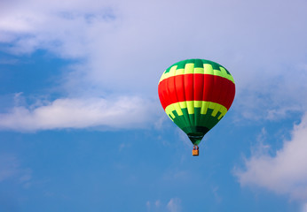 Colorful hot air balloon flying in blue sky
