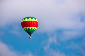 Colorful hot air balloon flying in blue sky