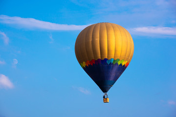 Fototapeta premium Colorful hot air balloon flying in blue sky