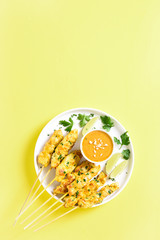 Grilled chicken skewers served with peanut dipping sauce