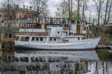 A pleasure yacht is moored to the shore