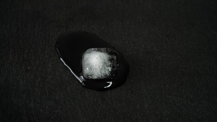 Close-up of melting ice cubes on black background