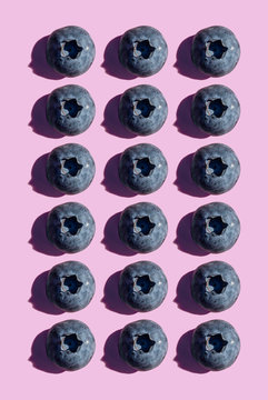 Blueberries in a row, pattern on purple background