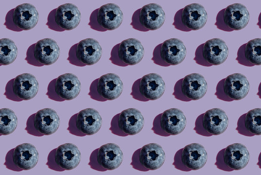 Blueberries in a row, pattern on purple background