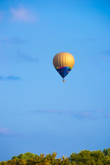 Colorful hot air balloon flying in blue sky