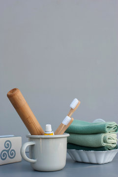Germany, Washclothes, bar of soap and mug with wooden toothbrushes and bamboo packaging