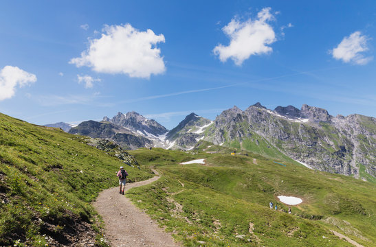 Switzerland, St Gallen Canton, Glarus Alps, Man hiking the Panoramic hiking trail in the Tectonic Arena Sardona