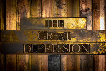 Photo of real authentic typeset letters forming The Great Depression text on vintage textured grunge copper and black background 