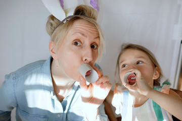 Portrait of mother and little daughter having fun together at home
