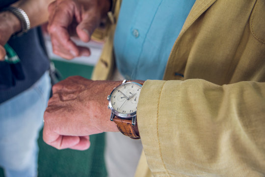 Close up of wrist watch, senior man checking the time