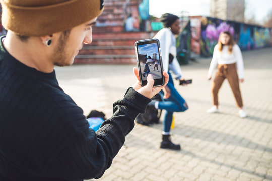 Young dancers rehearsing in a skate park, making a video