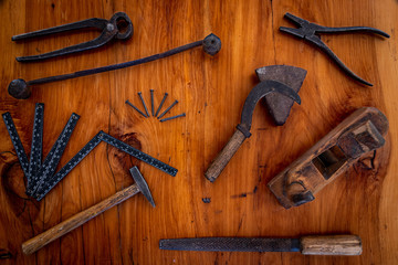 hammer, nails and other tools on wood