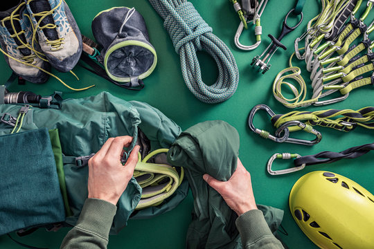 Overhead view of man packing climbing utensils
