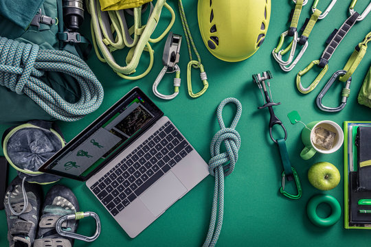 Overhead view of laptop and climbing equipment