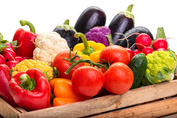 Vegetables in a wooden box. Harvest. Isolate on white background