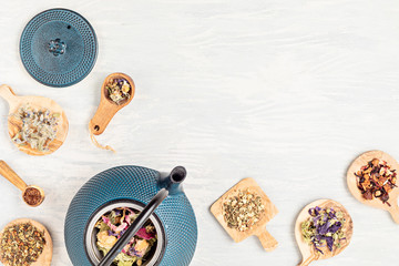 Traditional tea ceremony accessories, teapot and herbs and dry fruits tea. Destressing, relaxation, healing, healthy comforting, tea time, zen attitude concept. Top view