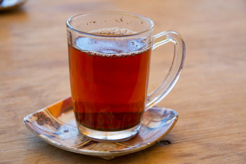 Glass of a traditional egyptian black tea served in the restaurant in St Catherine,Egypt. 
