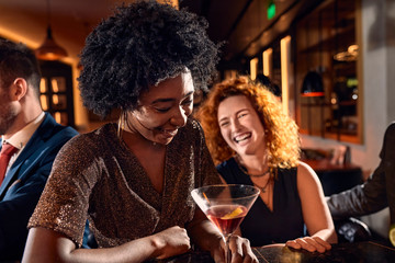Cheerful friends socializing in a bar