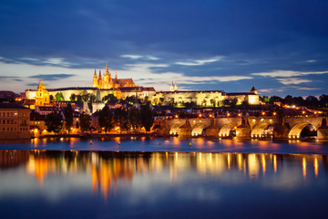 Evening view of the city. St. Vitus Cathedral in the evening. Charles bridge and Vltava river. Prague, Czech Republic