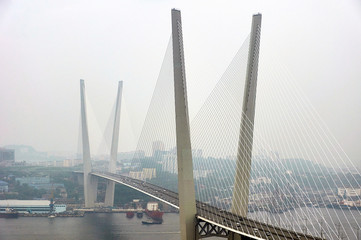 Fototapeta na wymiar Golden bridge in Vladivostok in the afternoon. Vladivostok, Russia.