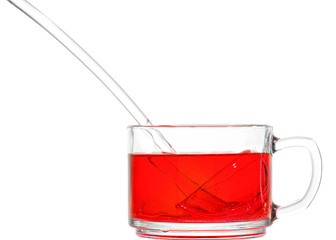 Cup with non-alcoholic cherry punch and glass ladle