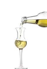 Absinthe pouring from a bottle into a tulip-shaped glass