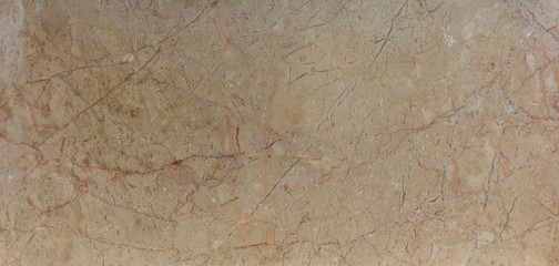 Close up on honey coloured veined marble background. Home decoration for the interior. Ceramic granite tile surface. High resolution matt marble texture used for architectural background.