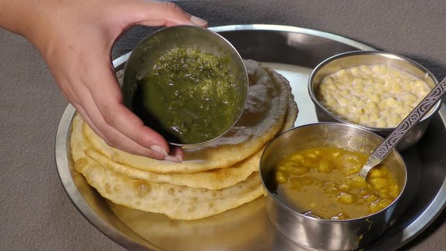 Showing various dishes in the plate of chole bhature