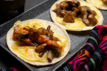 Mexican quesadillas with mushrooms on dark background