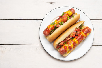Hot dog with pico de gallo salad on white background