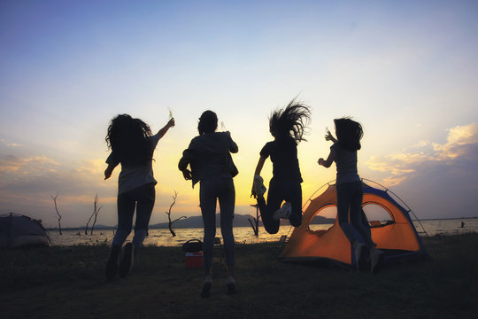 Close friend group jump up cheer while camping party at outdoor