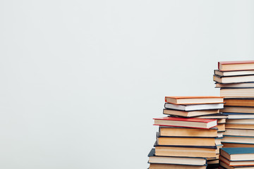 a lot of educational books for exams at the university on the white background of the library