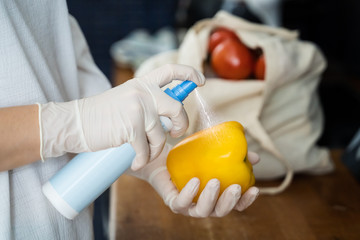 Woman Sanitizing Groceries And Other Food