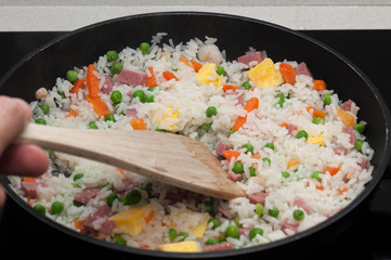 Rice three delights, with the wooden spade in its frying pan