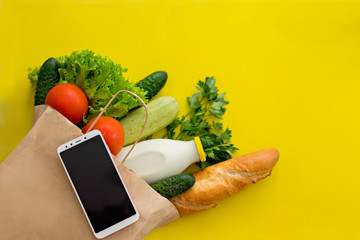 Healthy food background. Healthy vegan vegetarian food in paper bag vegetables and fruits on white, copy space, banner. Shopping food supermarket and clean vegan food concept. Food delivery online.