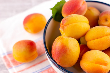 Fresh apricot on white wooden table. Ripe sweet berries in droplets of water