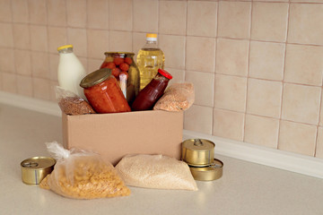 Humanitarian assistance during the coronavirus pandemic. Box with essentials, pasta, cereals and fruits.